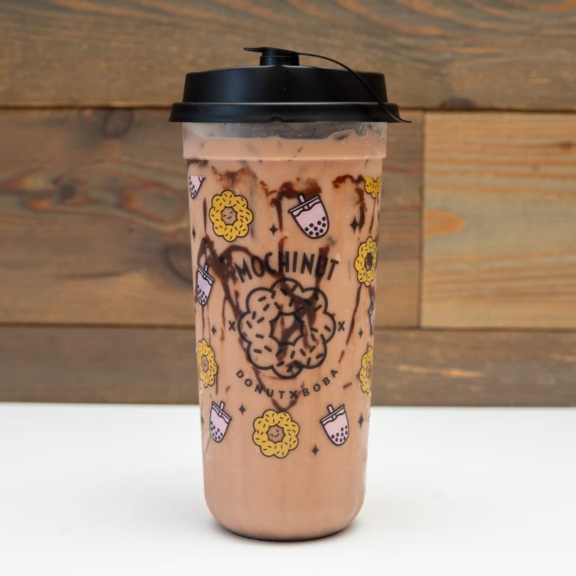 Mochinut chocolate boba tea with chocolate syrup drizzle in a branded cup.